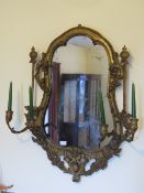 A continental gilded wall mirror having double-twin handle sconces to the fore 88cm high.
