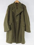 A British Army Great coat dated 1951, badged to REME, size 9.