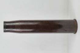 An inert US 90mm M71 shell case, approx. 60cm tall.