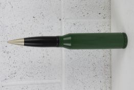 An inert anti aircraft round (green and black) measuring 39cm in length.