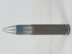 An inert 30mm TP M788 cannon round, 20cm in length.