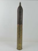 An inert WWII German 7.5cm Kwk40 hollow charge shell with markings upon.