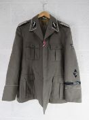 A repro WWII German tunic and trousers together with five hats/caps.