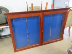 A large, 2 door, hardwood and glass, rifle display cabinet.