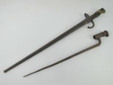 A Gras bayonet and scabbard together with a socket bayonet.