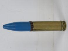 An inert British 30 x 113mm Aden round 20cm in length.