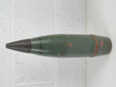 An inert 100mm shell head (green) 50cm in length.