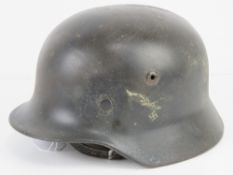 A WWII German M40 Luftwaffe helmet with liner and chin strap.