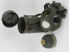 A WWII German AUER gas mask with filter and tin.