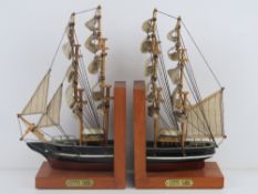 A pair of contemporary bookends in the form of the Cutty Sark complete with fabric sails,