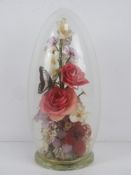 A 'captive garden' by Michael R Curzon having flowers and butterfly within, standing 30cm high.