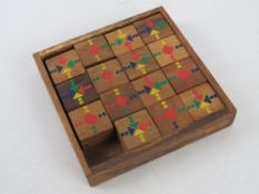 An Oriental wooden fifteen piece captive puzzle, two carved Oriental gourds, a shell 'caterpillar',