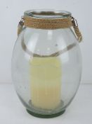 A contemporary glazed 'hurricane' lantern with battery powered candle within. 32cm high.
