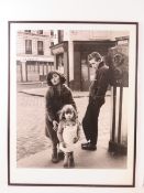 Photographic print; three children posing on French street, framed and glazed, overall 73.5 x 28cm.