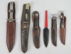 A quantity of a knives with scabbards.
