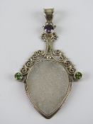 A large silver and druzy agate pendant having amethyst and peridots upon,