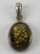 A silver and Baltic amber pendant, oval form, stamped 925, 2.6cm inc bale.