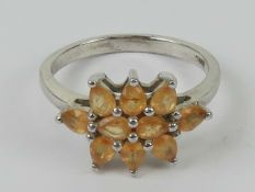 A silver and peach coloured stone cluster ring, stamped 925, size P.