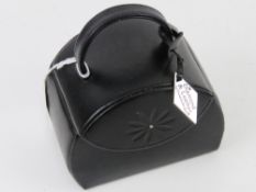 A leatherette jewellery box in the form of a clutch bag.