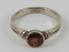 A silver and red stone ring, stamped 925, size O.