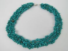 A large turquoise four row collar necklace, approx 47cm in length, silver clasp stamped 925.