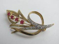 A 9ct gold floral brooch set with rubies, hallmarked 375, 4.5cm in length, 3.7g.