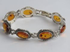 A contemporary silver and Baltic amber and marcasite bracelet, stamped 925, 20cm in length.