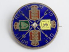 A Victoria 1887 silver crown, enamelled and mounted in brooch frame.