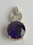 A silver purple stone pendant, stamped 925, 2.4cm in length.