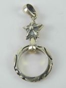 A silver pendant having star with rings suspended below,