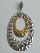 A 925 silver pendant having planished finish, 6cm in length.