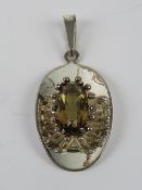 A silver pendant having central oval cut smoky quartz, stamped 925, measuring 4.5cm inc bale.