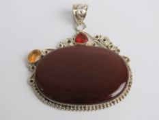 A large silver and hardstone pendant, approx 5.4cm wide.