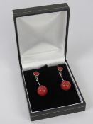 A pair of modern faux coral and silver earrings, stamped 925, with butterfly backs,