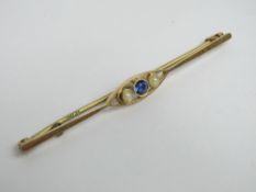 An 18ct gold sapphire and seed pearl bar brooch, stamped 18ct, 5.6cm wide, 1.9g.