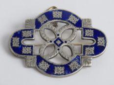 A large and heavy white metal brooch having blue enamel foliate pattern, 5.2cm wide.