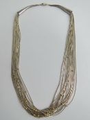 A sterling silver Native American Navajo style beaded chain necklace, twenty strands,