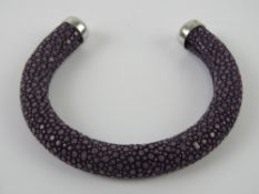 A unusual Ray skin bangle in purple.