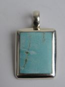 A hallmarked silver and turquoise pendant, 3.8cm inc bale.