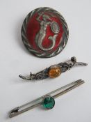 A sterling silver green stone bar brooch together with a Baltic amber brooch and an enamelled