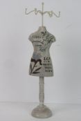 A jewellery stand in the form of a mannequin.