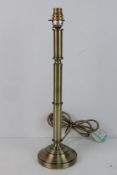 A single brass column table lamp.