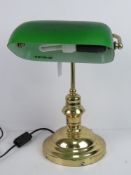 A brass 'bankers' lamp with green glass shade.