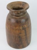 A large turned wooden vase.