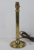 A single brass column style table lamp.