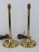 A pair of brass table lamps of column form.