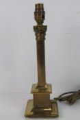 A single brass column table lamp.