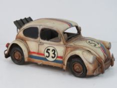 A contemporary metal model of a VW beetle No53 with racing stripes.