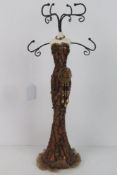 A jewellery stand in the form of a mannequin.