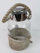 A contemporary 'storm lantern' having rope design on glass jar, solar panel untested,